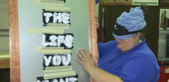 student showing lettering "Life the life you want!"