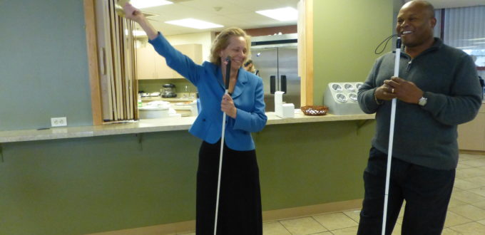 a woman rings her freedom bell, smiling broadly