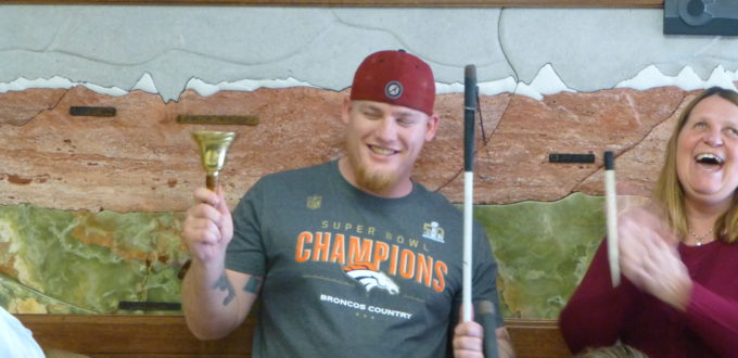 Daniel smiles and rings his bell