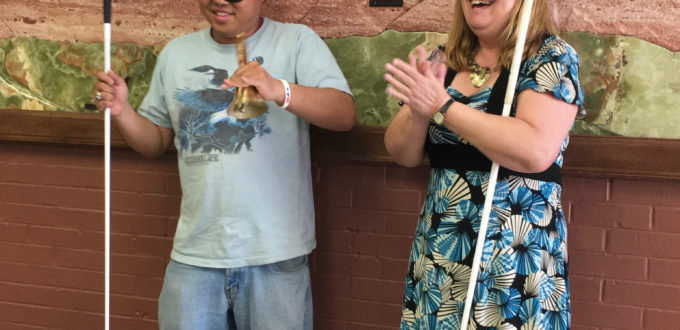 Joey grins as he rings his Bell of Freedom