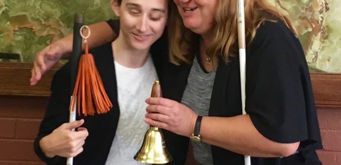 Julie hugging Haylee and presenting the Bell - Big Smiles and warm hugs