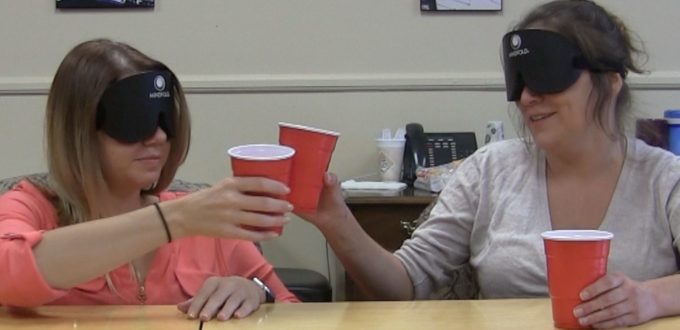 Two women touch glasses