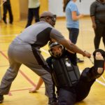 Jimmi throws Rachael to the ground while keeping hold of his cane