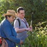 Master Gardener shows new student (David) around the garden
