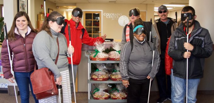 A group of CCB students pose around a cart with six large trays of goodies to give out