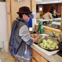 Alejandro peels apples for baked apple dessert for his Graduation Meal