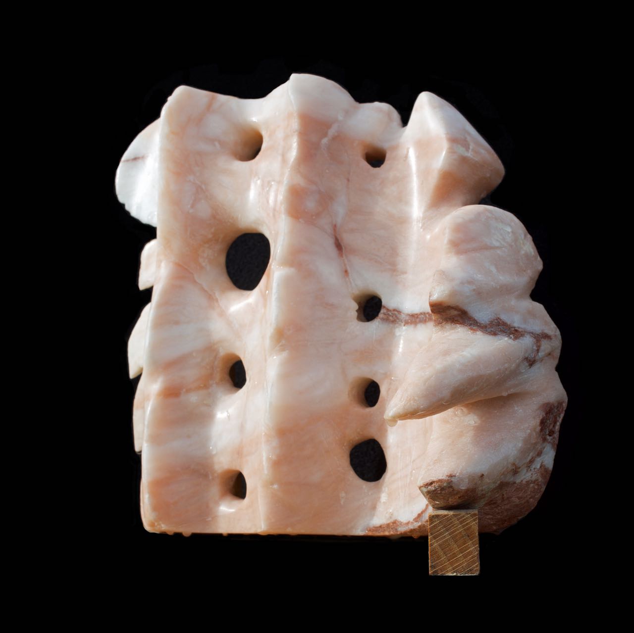 An alabaster sculpture with flowing and spiky elements