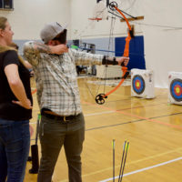 Charles takes aim with his bow in Archery Class