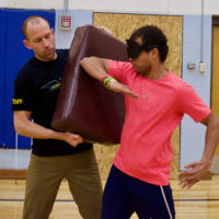 Chaz throwing elbow jabs at the pad in Martial Arts Class