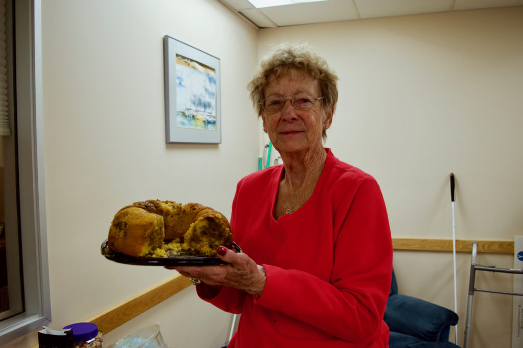 Dorine holding up her award-winning Cinnamon Pudding Cake