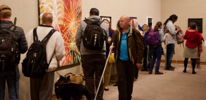 CCB students take turns exploring numerous tactile art pieces on the walls