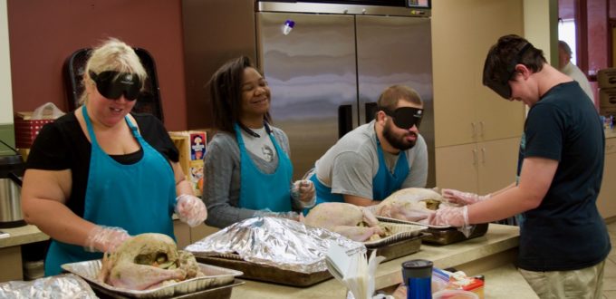 Lia, Ravi, Mason S. and Mason M. prepare four large turkeys to go into the ovens