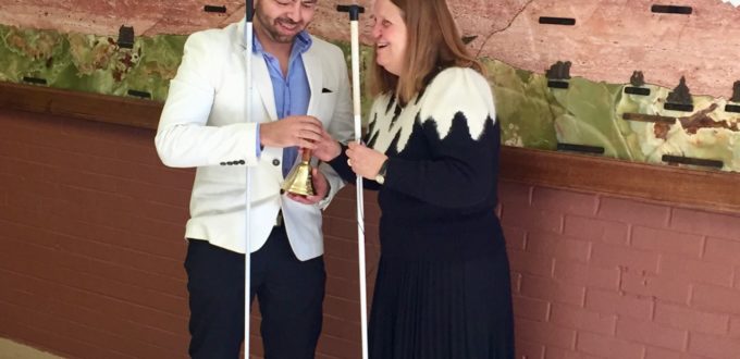 Julie handing Cesar his Freedom Bell