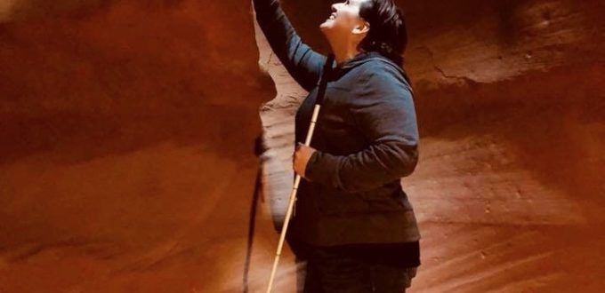 Libby with her cane exploring the wind and water whipped canyon walls at Antalope Canyon Arizona