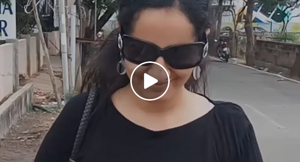 Poonam walking down a street in India for BC Video