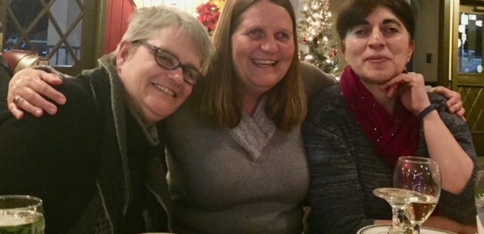 Cathy, Julie and Anahit smiling across the table at a local restaurant