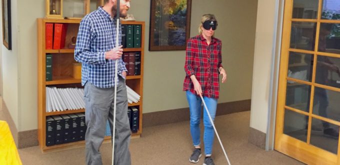 Kirsten with David working on cane travel in the front lobby