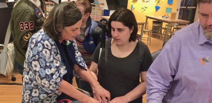 Ann explores tactile art with a group of blind students at the Denver Art Museum