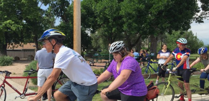 CCB Summer students Mary and Cheyene get on the tandem bikes with EyeCycle Volunteers while Christina waits her turn