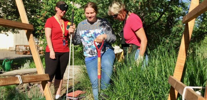 Amber using a shovel in the garden for the 1st time with Annette and Barb