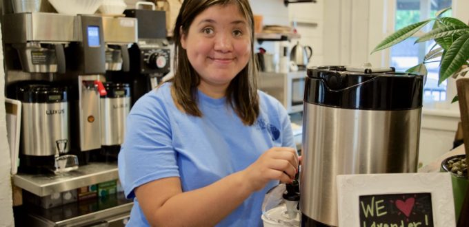 Beth at the coffee machine behind the counter at Dirt Coffee