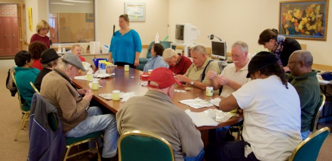 A group of a dozen seniors along with CCB staff work on making sugar scrub
