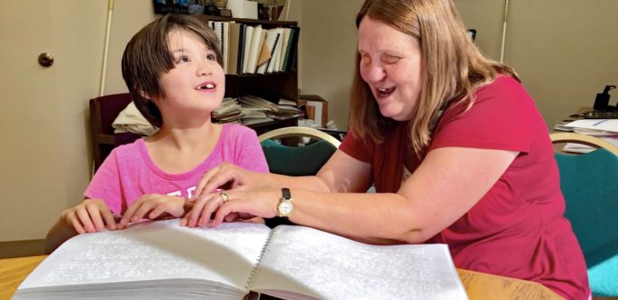 Julie and Lexi Reading Braille