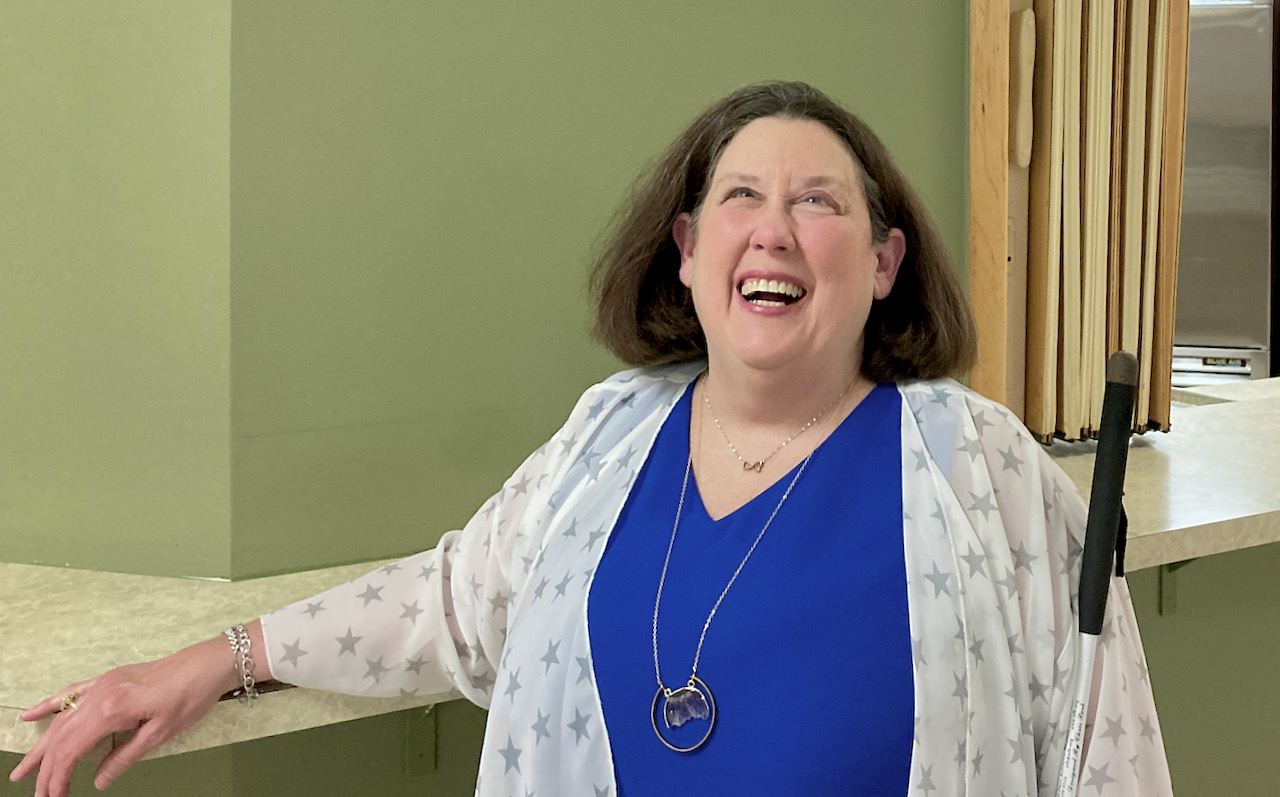 smiling woman shows off her new necklace